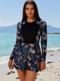 2026 Women's Exotic Swimdress: Navy Blue Tropical Leaf Print Long-Sleeve One-Piece with Solid Black Chest Panel and Front Half-Zip
